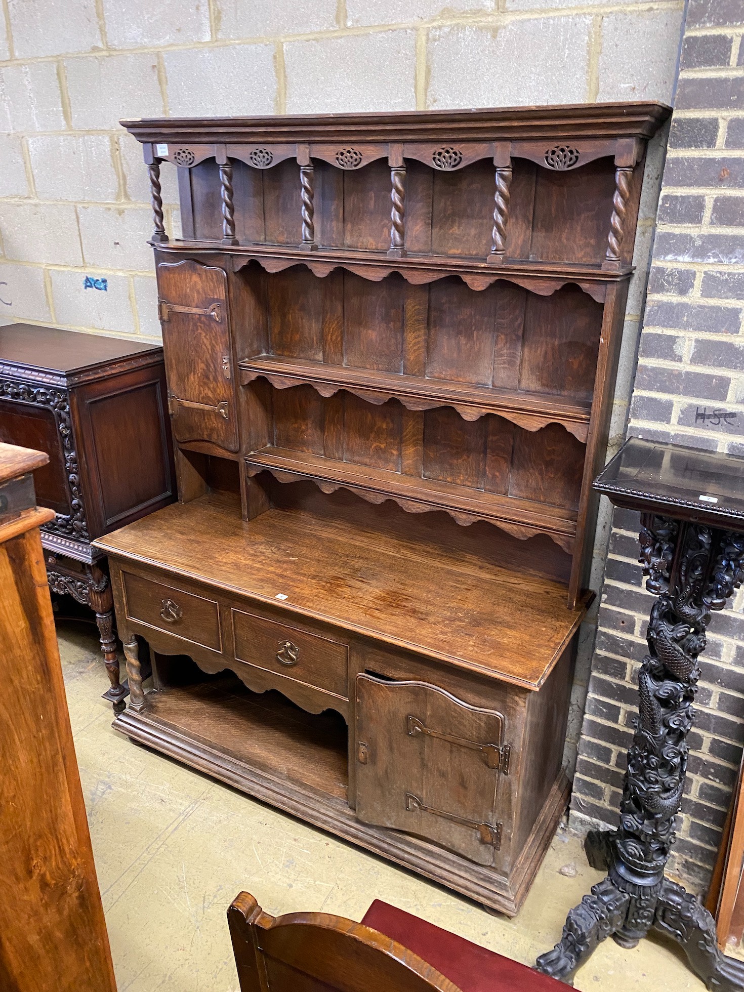 An Arts & Crafts copper mounted oak dresser, width 153cm, depth 53cm, height 210cm